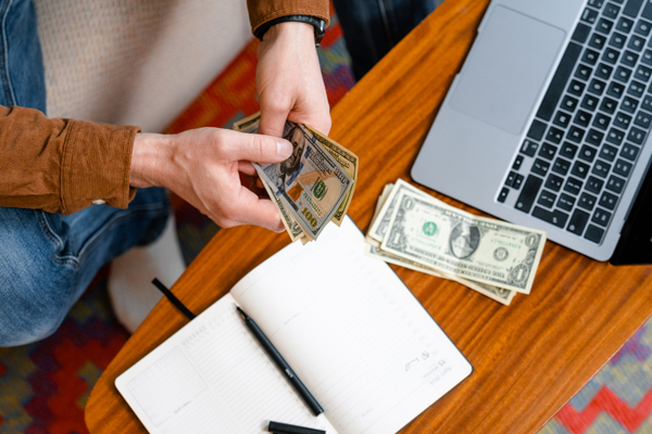 Man counts money to pay utility bills