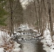 image of stream during winter with snow on the stream banks.