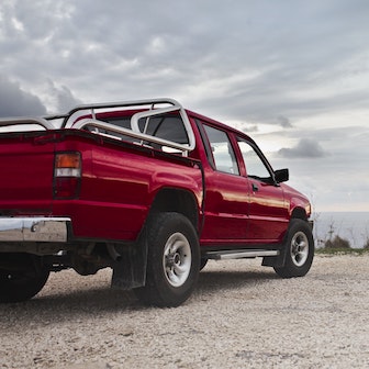 A red truck along a dirt road